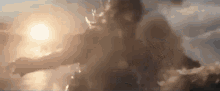 a person is flying through the air with the sun shining through the clouds behind them .