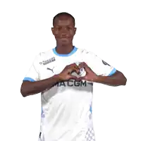 a man in a macom jersey making a heart shape with his hands