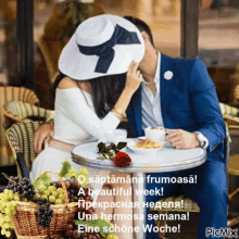 a picture of a man and woman sitting at a table with a basket of grapes