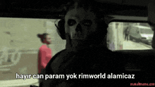 a man in a skull mask is sitting in a car with the words hayir can param yok rimworld alamicaz