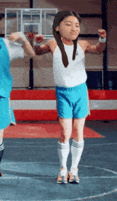 a girl in blue shorts is jumping in the air