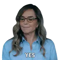a woman wearing glasses and a blue shirt has the word yes on her face
