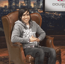a man wearing a grey sweatshirt that says stay pretty