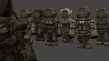 a group of soldiers are standing next to each other and one of them has the letter t on his back