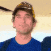a man wearing a hat that says lana seth looks at the camera