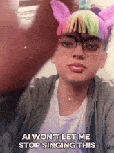 a girl wearing a unicorn headband and glasses says ai won t let me stop singing this