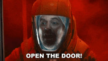 a man in a space suit with the words open the door behind him