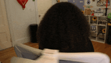 a woman 's head is visible in front of a shelf with a sign that says chow chowarma
