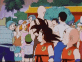 a group of cartoon characters are standing next to each other and one of them has a dragon ball z logo on his shirt .