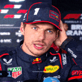 a man wearing a hat that says oracle racing on it