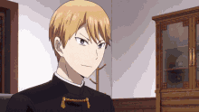 a man with blonde hair is wearing a black jacket