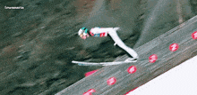 a ski jumper is flying through the air on skis