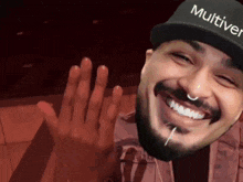 a man with a beard is wearing a hat that says " multivi " on it
