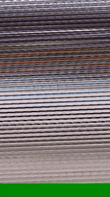 a close up of a stack of papers with a green border