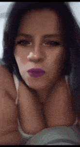 a woman with purple lipstick on her lips