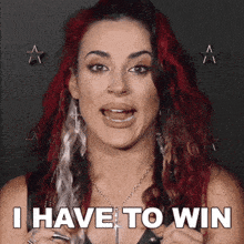 a woman with red and white hair says i have to win