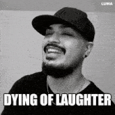 a black and white photo of a man laughing with the words dying of laughter underneath him