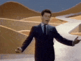 a man in a suit and tie is singing into a microphone .