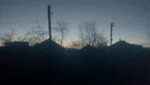 a sunset with a few houses in the background