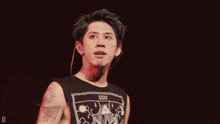 a man with green hair is wearing a black shirt