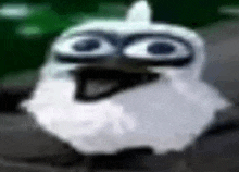 a close up of a white bird with a beard and big eyes .