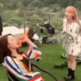 two women are standing next to each other on a patio .