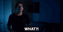 a man in a black shirt says " what "