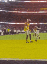 a football player in a yellow jersey is kicking a ball