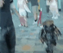 a blurred image of people walking in a crowd
