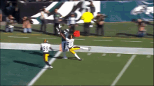 a football player with the number 33 on his jersey is catching a ball