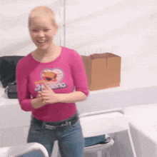 a woman wearing a pink shirt that says 24 swing on it