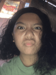 a girl with curly hair making a funny face