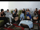 a group of people sitting around a table with one wearing a hat that says ' sd ' on it