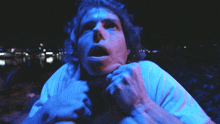 a blurry picture of a person 's face with blue lights behind them