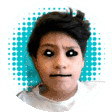 a young boy with black eyes is making a face .