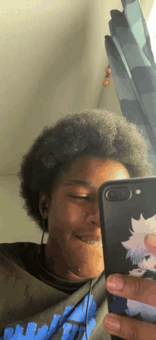 a young man taking a picture of himself with his cell phone