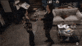 a man and a woman are dancing in a living room with abc written on the bottom right