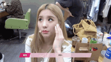a woman with blonde hair has a pink sticker on her face that says ' a '