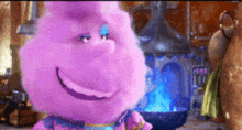 a purple stuffed animal is smiling and standing in front of a gingerbread man .