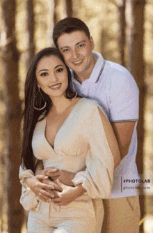 a man and a woman are posing for a picture with the hashtag #photolab