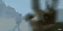 a blurred image of a plane flying in the sky