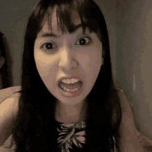 a woman making a face with her mouth open