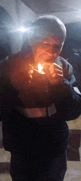 a man is lighting a cigarette with a lighter in his hand .