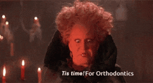 a picture of a witch with the words tis time for orthodontics at the bottom