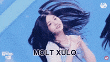 a girl with her hair blowing in the wind with the words molt xulo written below her