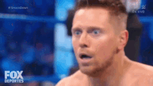 a man without a shirt is making a surprised face during a wrestling match on fox deportes