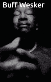 a black and white photo of a man with his hands folded and the name buff wesker above him