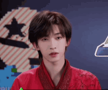 a young man wearing a red kimono is standing in front of a pixel art .
