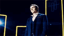 a man in a suit is standing in front of a sign that says ' 00 ' on it