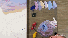a painting is being painted on a wooden table and the palette is made in animatica